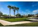 Well-maintained neighborhood featuring lush landscaping and palm trees at 368 Perth Ct # 368, Dunedin, FL 34698