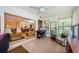 Bright sun room with a piano, comfortable recliner, and large windows, perfect for relaxation and entertaining at 368 Perth Ct # 368, Dunedin, FL 34698