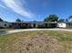 Single-story home with neutral paint, solar panels, well-maintained lawn, and an attached garage at 378 79Th Ne Ave, St Petersburg, FL 33702