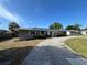 Single-story home with neutral paint, solar panels, well-maintained lawn, and an attached garage at 378 79Th Ne Ave, St Petersburg, FL 33702