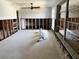 Empty Living Room with exposed wall studs, a ceiling fan, and large windows at 378 79Th Ne Ave, St Petersburg, FL 33702