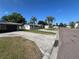 A street view showcasing a well-kept home with a nice lawn, complemented by palm trees and a driveway at 378 79Th Ne Ave, St Petersburg, FL 33702