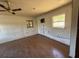 Bedroom with wood flooring, three windows, and ceiling fan, offering natural light at 37810 Silver Pines Ave, Zephyrhills, FL 33542