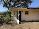 Exterior view of the back of the building with open back door entrance and window at 37810 Silver Pines Ave, Zephyrhills, FL 33542