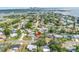 Aerial view of neighborhood near waterfront with house indicated by red arrow and cityscape in the distance at 3843 Neptune Se Dr, St Petersburg, FL 33705
