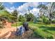Backyard featuring patio, tropical landscaping, grill, and playset with slide at 3843 Neptune Se Dr, St Petersburg, FL 33705