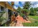 Outdoor patio area surrounded by lush landscaping and vegetation at 3843 Neptune Se Dr, St Petersburg, FL 33705