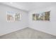 Bright bedroom featuring neutral carpet, fresh paint, and dual windows letting in natural light at 3843 Neptune Se Dr, St Petersburg, FL 33705