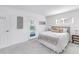 Cozy bedroom features neutral tones, soft lighting, and private patio access at 3843 Neptune Se Dr, St Petersburg, FL 33705