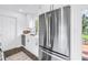 Modern kitchen design with stainless steel appliances, white cabinetry, and backyard access at 3843 Neptune Se Dr, St Petersburg, FL 33705