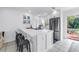 Modern kitchen featuring a spacious island with barstool seating, stainless steel appliances and a bright interior at 3843 Neptune Se Dr, St Petersburg, FL 33705