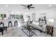 Bright and open living room featuring white walls, ceiling fan, modern furnishings, and view to the dining area at 3843 Neptune Se Dr, St Petersburg, FL 33705