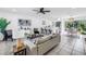 A bright and airy living room with an open floor plan and neutral decor that flows into the dining area at 3843 Neptune Se Dr, St Petersburg, FL 33705