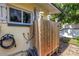 Private outdoor shower featuring wood enclosure, dual shower heads and convenient hose connection at 3843 Neptune Se Dr, St Petersburg, FL 33705