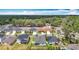 Aerial view of the neighborhood, highlighting tree coverage around the homes, and the home's backyard and landscaping at 3891 Reflection Dock Dr, Seffner, FL 33584