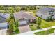 Attractive home with lush green lawn, positioned with nearby solar panels and a serene pond as a backdrop at 3891 Reflection Dock Dr, Seffner, FL 33584