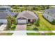 An eye-catching aerial shot of the property with a manicured lawn, and a tranquil pond in the distance at 3891 Reflection Dock Dr, Seffner, FL 33584