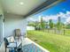 Inviting covered patio overlooking a grassy backyard, perfect for relaxation and outdoor enjoyment at 3891 Reflection Dock Dr, Seffner, FL 33584