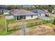 A well maintained home's backyard features a black metal fence with a covered patio area with outdoor furniture at 3891 Reflection Dock Dr, Seffner, FL 33584