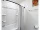 Bright bathroom with a white shower tub and curtain at 3891 Reflection Dock Dr, Seffner, FL 33584