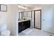 Modern bathroom with a double granite vanity, walk-in shower with glass enclosure, and white tiled walls at 3891 Reflection Dock Dr, Seffner, FL 33584