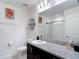 A bathroom with a toilet, sink, mirror, and walk-in shower at 3891 Reflection Dock Dr, Seffner, FL 33584