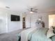 Bright bedroom boasts a ceiling fan, plush carpet, and recessed lighting at 3891 Reflection Dock Dr, Seffner, FL 33584