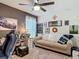 Bedroom featuring a cozy couch, desk, ceiling fan, and decor at 3891 Reflection Dock Dr, Seffner, FL 33584