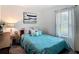 Bedroom with a bed, a nightstand, and a window at 3891 Reflection Dock Dr, Seffner, FL 33584
