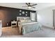 Bedroom with dark accent wall, plush carpet, and bright natural light at 3891 Reflection Dock Dr, Seffner, FL 33584