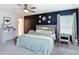 Bedroom features dark accent wall, plush carpet, and bright natural light at 3891 Reflection Dock Dr, Seffner, FL 33584