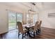 A dining room with a wooden table, six chairs, and a sliding glass door at 3891 Reflection Dock Dr, Seffner, FL 33584