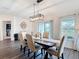Dining room with wood floors, a modern light fixture, and sliding glass doors at 3891 Reflection Dock Dr, Seffner, FL 33584