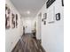 Inviting hallway with wood-look floors and charming decor creates a warm welcome at 3891 Reflection Dock Dr, Seffner, FL 33584
