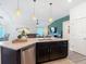 Open kitchen connects seamlessly with living area, featuring granite countertops and stainless steel appliances at 3891 Reflection Dock Dr, Seffner, FL 33584