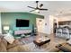 Comfortable living room with open layout into kitchen, featuring a sleek entertainment center and cozy seating at 3891 Reflection Dock Dr, Seffner, FL 33584