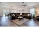 Spacious living room with plush seating, neutral tones, and bright natural light from surrounding windows at 3891 Reflection Dock Dr, Seffner, FL 33584