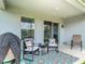 Cozy covered patio featuring comfortable seating, a stylish rug, and tranquil outdoor living space at 3891 Reflection Dock Dr, Seffner, FL 33584