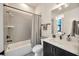 Modern bathroom featuring a shower-tub combination and vanity with a gray and white color scheme at 4047 Gauge Line Loop, Tampa, FL 33624