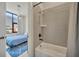 Modern bathroom with large window, neutral tile, a bathtub, and a view of the connected bedroom at 4047 Gauge Line Loop, Tampa, FL 33624