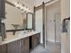 Contemporary bathroom with double vanity, dark cabinets, sliding glass door, and modern fixtures at 4047 Gauge Line Loop, Tampa, FL 33624