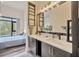 Bathroom featuring double vanity, dark wood cabinets, quartz countertops and a decorative plant at 4047 Gauge Line Loop, Tampa, FL 33624