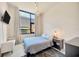 Cozy bedroom featuring a large window, modern pendant lighting, and a sleek, minimalist design at 4047 Gauge Line Loop, Tampa, FL 33624