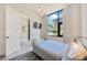 Comfortable bedroom with large window, pendant lighting, TV and bench; light and bright at 4047 Gauge Line Loop, Tampa, FL 33624