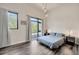 Inviting bedroom with modern lighting, large window, and neutral decor at 4047 Gauge Line Loop, Tampa, FL 33624