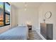 This bedroom has a minimalist decor, a view from the window, and a modern round mirror at 4047 Gauge Line Loop, Tampa, FL 33624