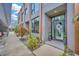 Chic townhouse entrance with a glass front door and well-maintained landscaping at 4047 Gauge Line Loop, Tampa, FL 33624