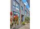 Stylish townhouse exterior with large windows reflecting the sky and modern landscaping at 4047 Gauge Line Loop, Tampa, FL 33624