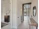 Open foyer view with modern staircase, console table and exterior view at 4047 Gauge Line Loop, Tampa, FL 33624
