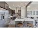 Open kitchen area with stainless appliances, large island, and modern pendant lights at 4047 Gauge Line Loop, Tampa, FL 33624
